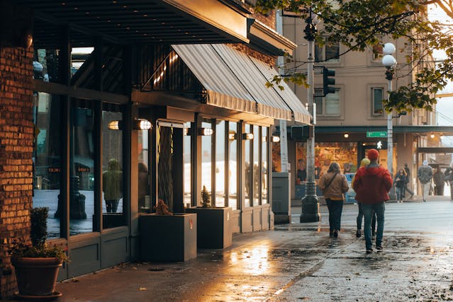 People Walking in Front of Glass Building