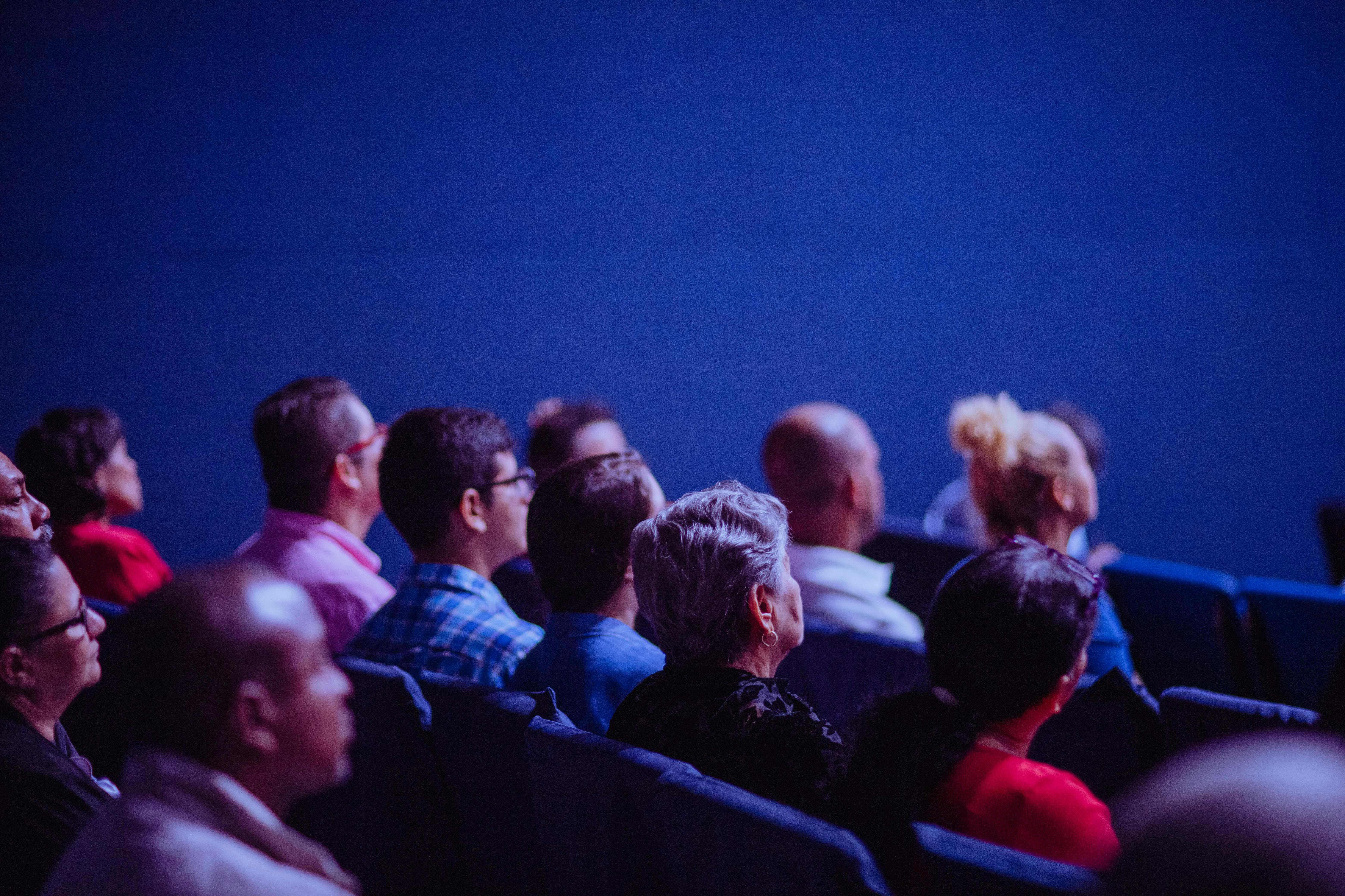 people sitting in theatre seats